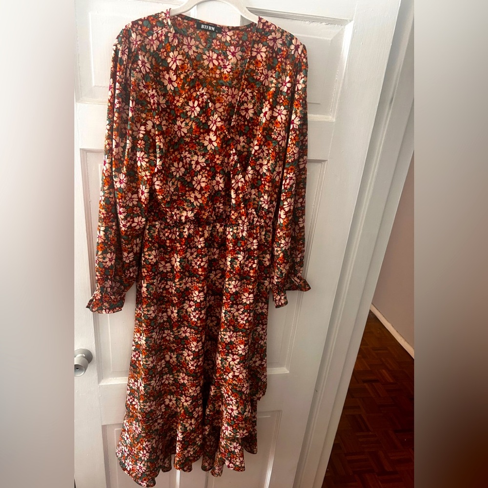 Floral long sleeve crepe dress. Ruffled hem, hits at mid ankle.